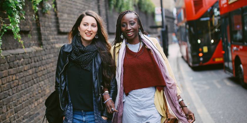 Two young women walking and chatting