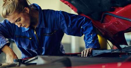 Female mechanic fixing car