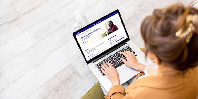 Woman looking at a MoneyHelper page on her laptop