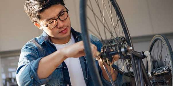 Man fixing bicycle wheel