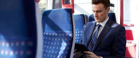Man wearing suit seated on bus