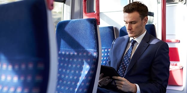 Man wearing suit seated on bus